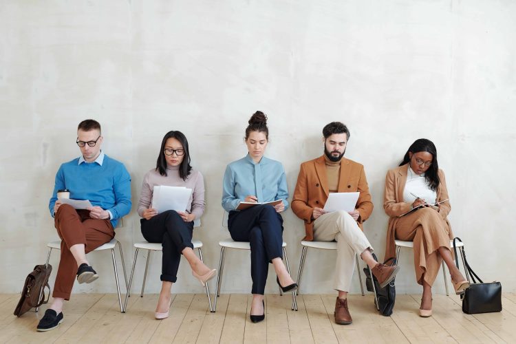 Candidates for jobs sitting with papers Candidates for jobs sitting with papers