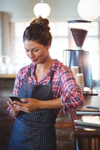 Waitress using a smartphone Waitress using a smartphone
